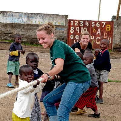 Projects Abroad volunteers work with children in Ghana. Childcare volunteer plays a game with children during her work experience in Ghana.